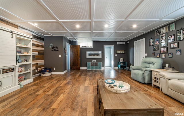 living room with hardwood / wood-style floors and a barn door