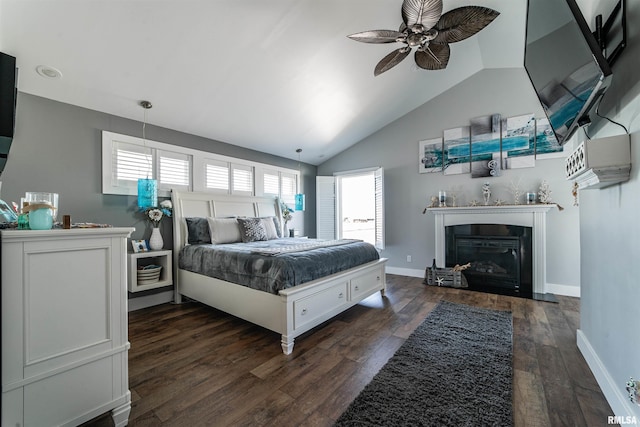 bedroom with dark hardwood / wood-style flooring, vaulted ceiling, and ceiling fan