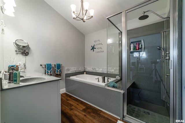 bathroom featuring a notable chandelier, lofted ceiling, separate shower and tub, and wood-type flooring