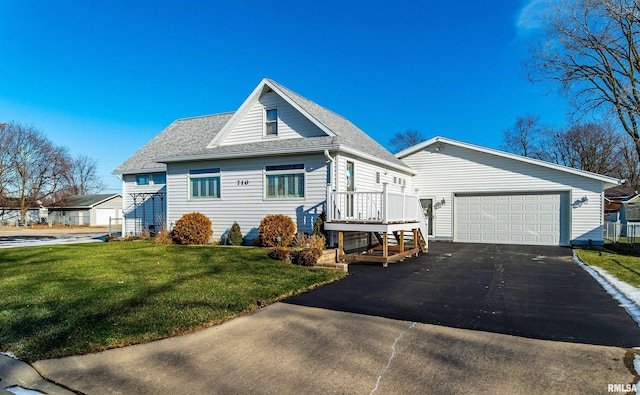 view of front of home with a garage and a front lawn