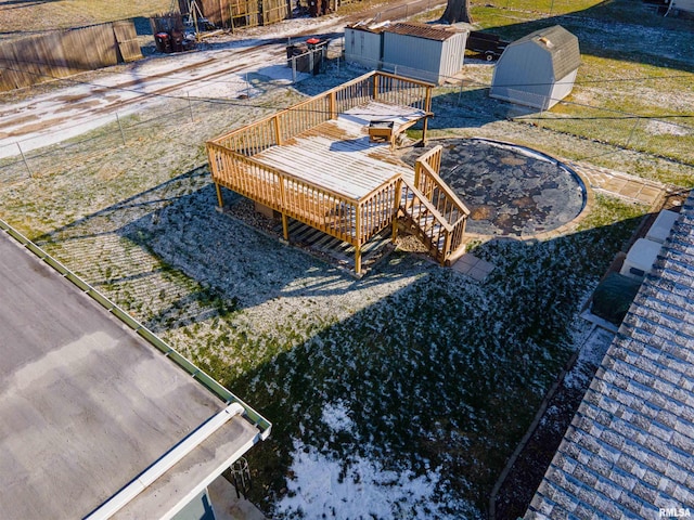 view of yard with a storage shed, a trampoline, and a wooden deck