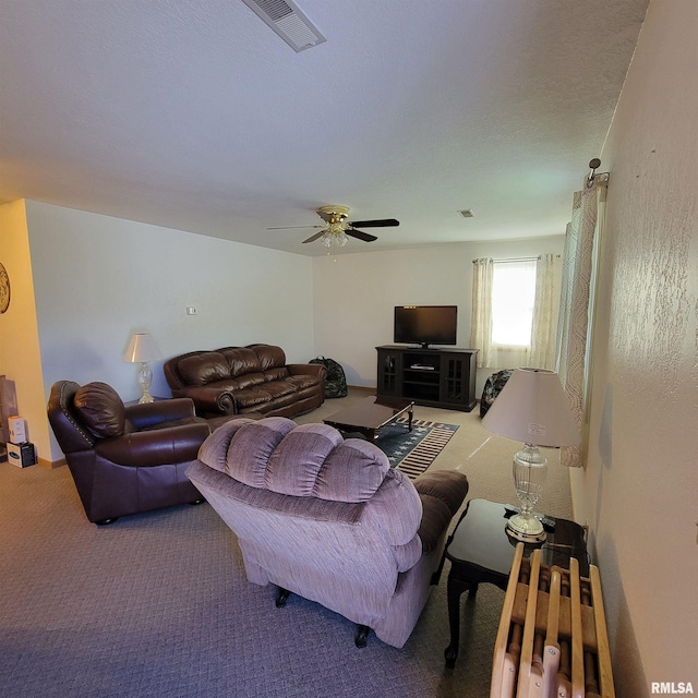 carpeted living room with ceiling fan