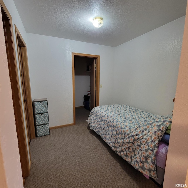 bedroom with a textured ceiling and carpet floors