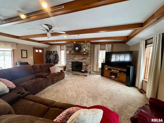 living room featuring a fireplace, ceiling fan, beamed ceiling, and carpet