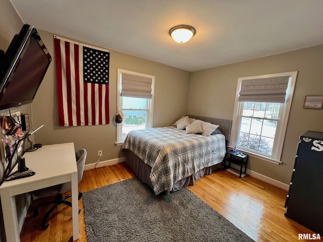 bedroom featuring light hardwood / wood-style flooring and multiple windows