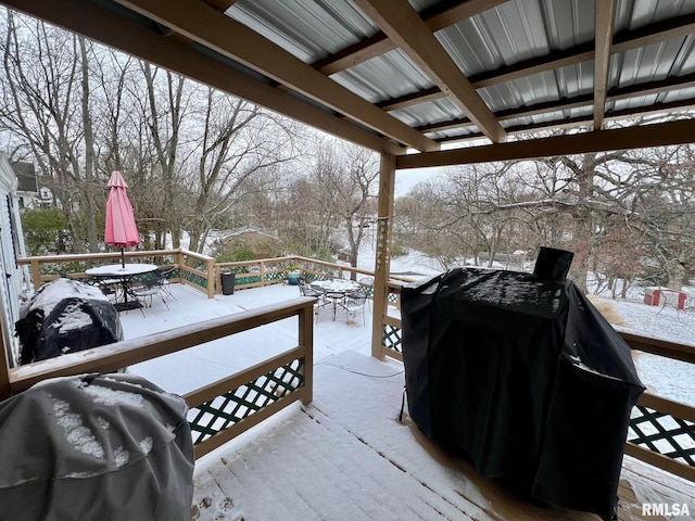 snow covered deck with a grill