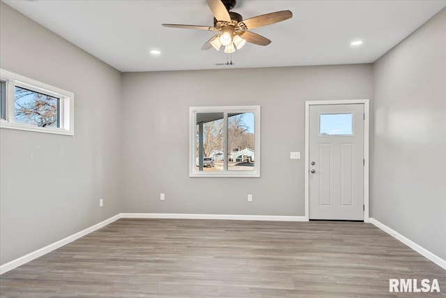 foyer with ceiling fan and light wood-type flooring