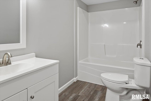 full bathroom featuring vanity, hardwood / wood-style flooring, toilet, and shower / washtub combination