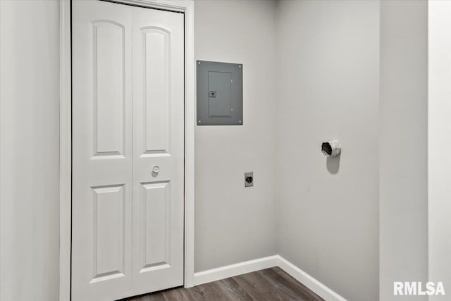 laundry room featuring hookup for an electric dryer, dark hardwood / wood-style flooring, and electric panel