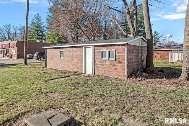 view of outbuilding with a lawn