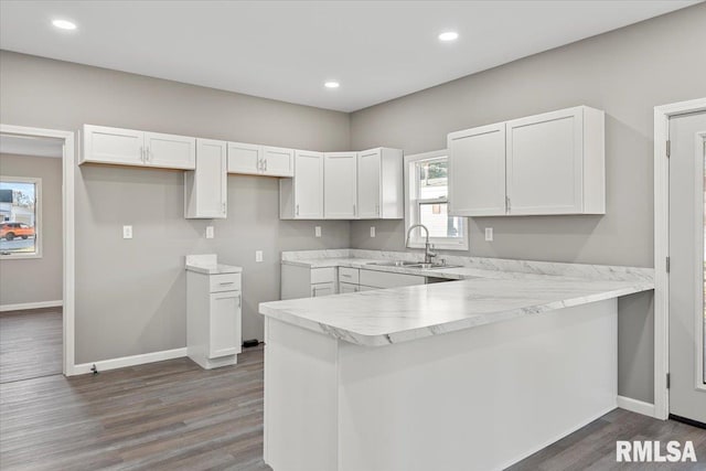 kitchen featuring white cabinets, plenty of natural light, and dark hardwood / wood-style floors