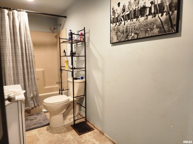 bathroom featuring toilet, tile patterned floors, and shower / tub combo with curtain