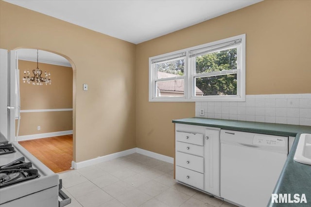 kitchen featuring white cabinets, tasteful backsplash, pendant lighting, a notable chandelier, and dishwasher