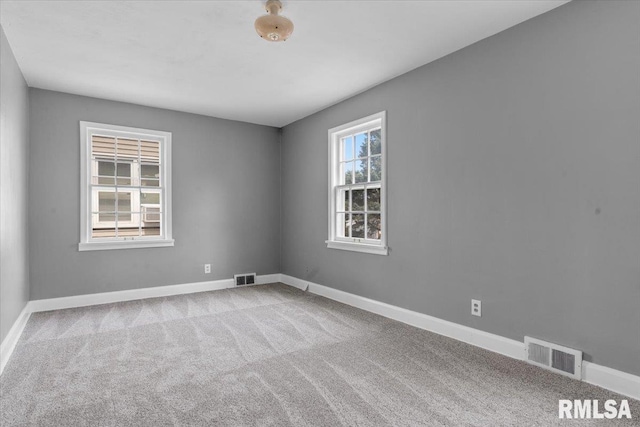 unfurnished room featuring light colored carpet