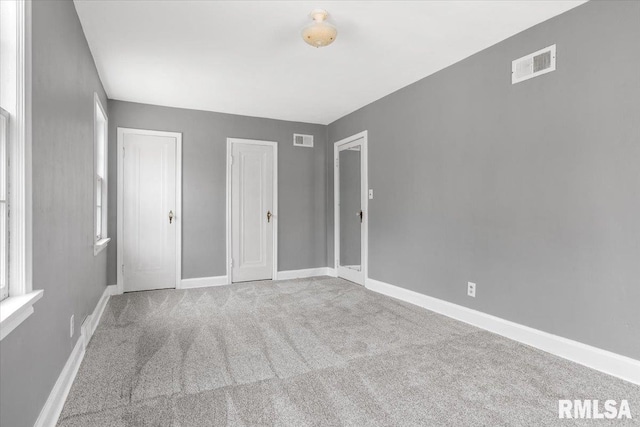 unfurnished bedroom featuring light carpet