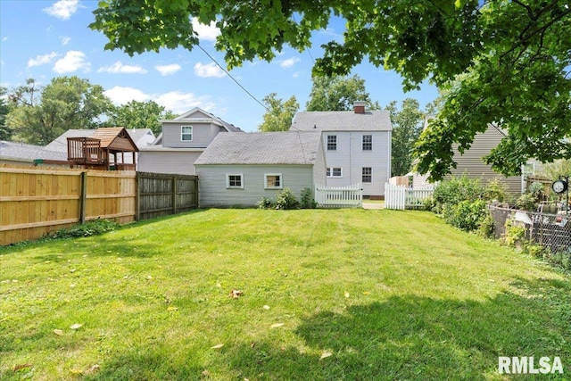 back of house with a yard