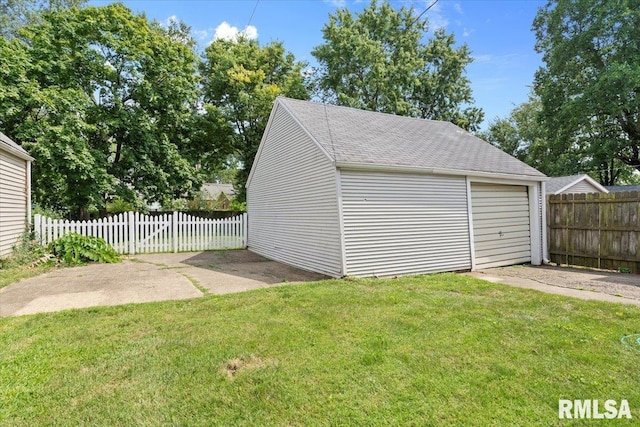 garage featuring a lawn