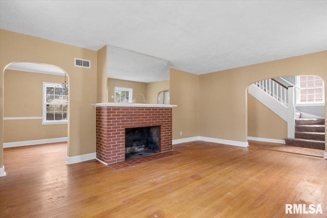 unfurnished living room with a fireplace and hardwood / wood-style flooring