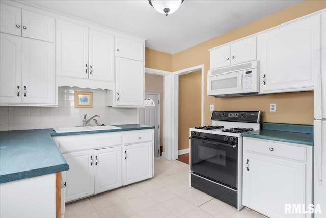 kitchen with decorative backsplash, sink, white cabinets, and white appliances