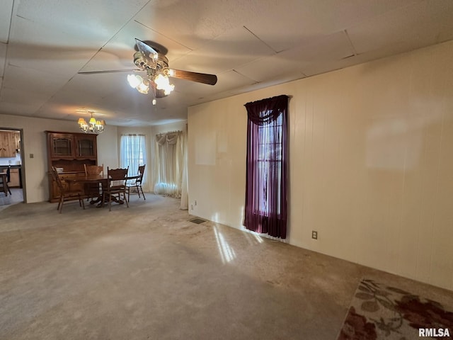 dining space with ceiling fan with notable chandelier