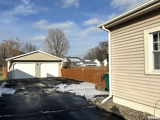 view of side of property with a garage and an outbuilding