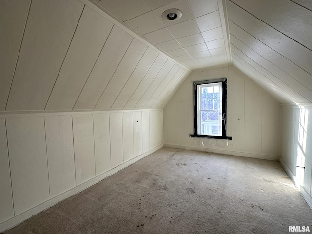 bonus room featuring light colored carpet and lofted ceiling