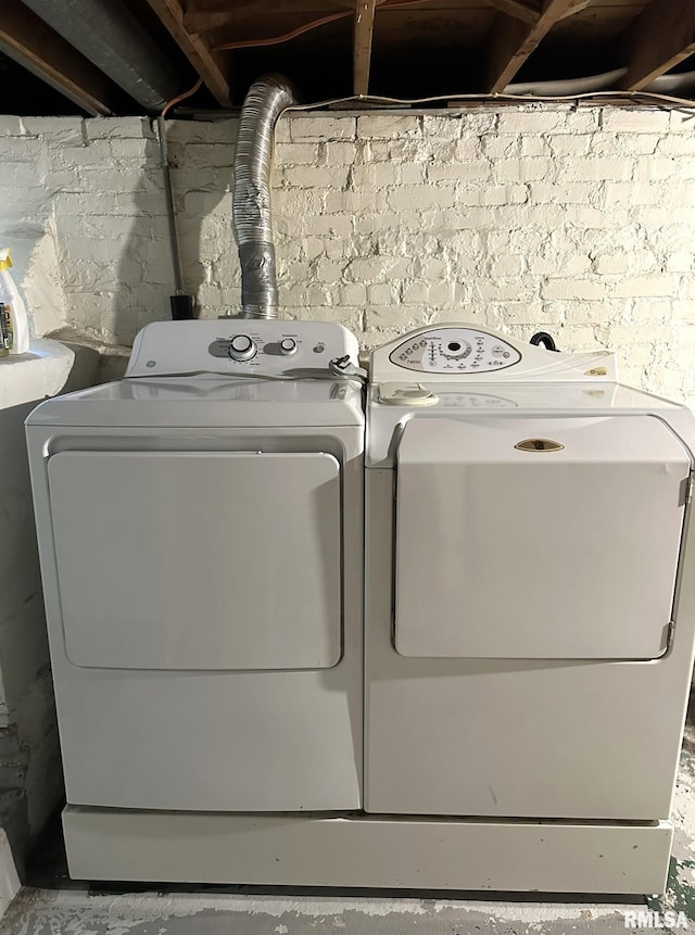 clothes washing area with washer and clothes dryer