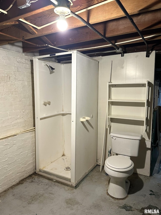 bathroom with concrete flooring and toilet