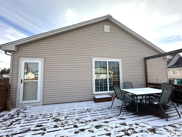 snow covered property with a wooden deck