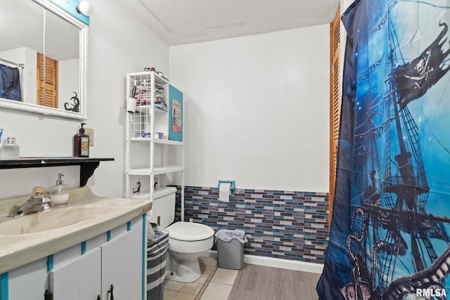 bathroom featuring vanity, hardwood / wood-style flooring, and toilet