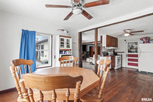 dining space featuring ceiling fan, dark hardwood / wood-style floors, and a textured ceiling