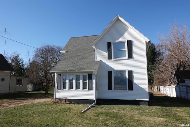 rear view of property with a lawn