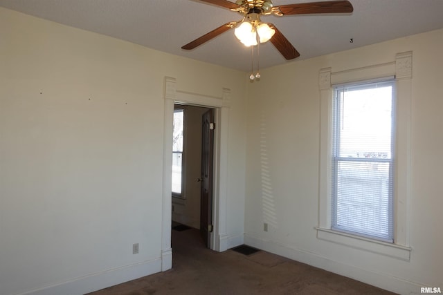 carpeted empty room featuring ceiling fan