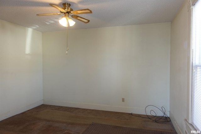 unfurnished room featuring a textured ceiling, a wealth of natural light, and ceiling fan