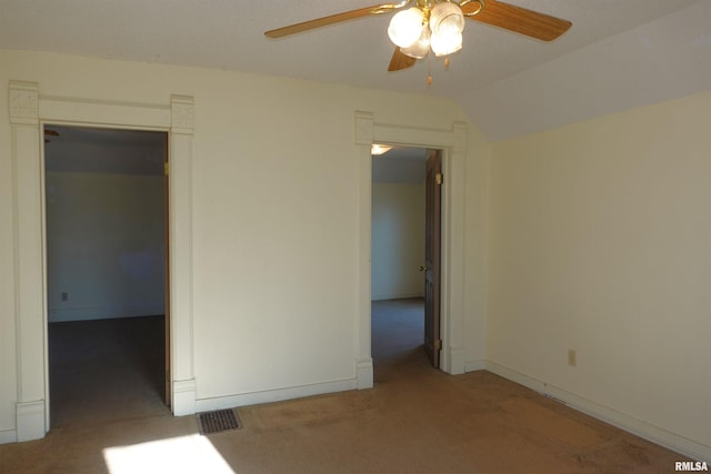 carpeted empty room featuring ceiling fan and lofted ceiling