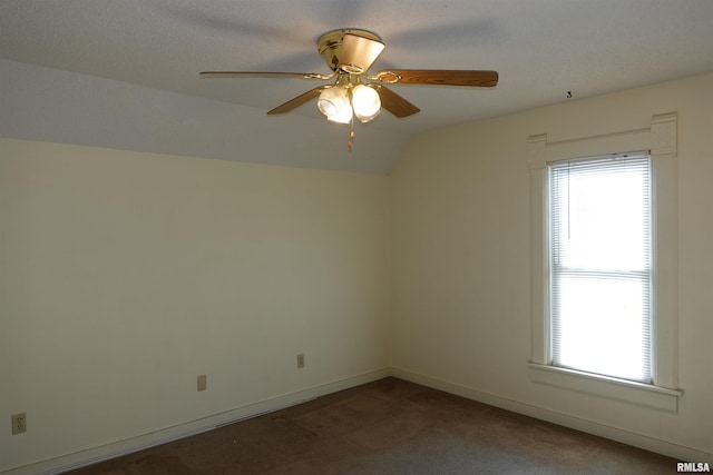 unfurnished room featuring carpet flooring, ceiling fan, a textured ceiling, and vaulted ceiling