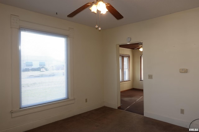 carpeted spare room featuring plenty of natural light and ceiling fan