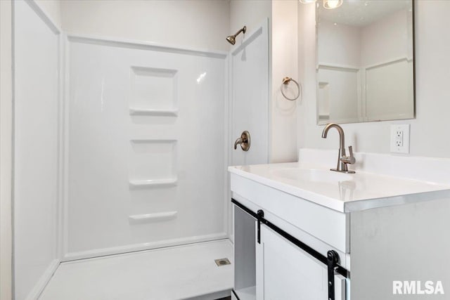 bathroom with a shower and vanity