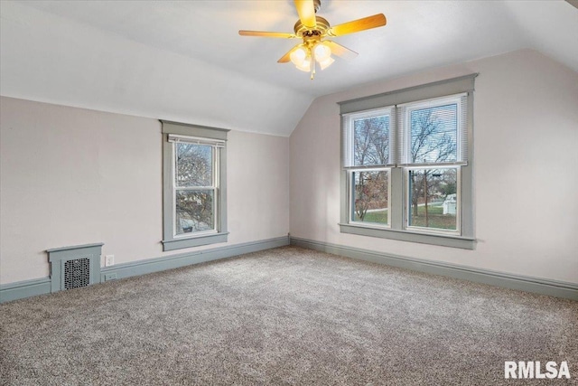 additional living space featuring carpet, vaulted ceiling, and a wealth of natural light