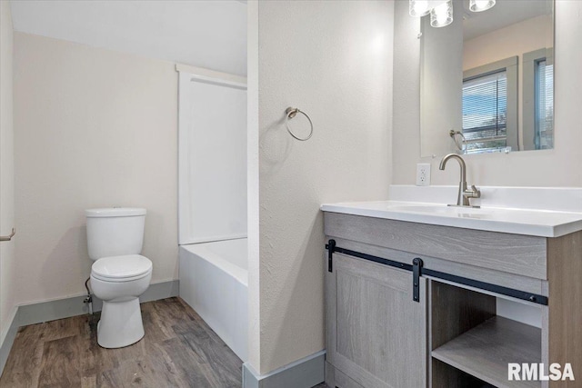 bathroom featuring hardwood / wood-style floors, vanity, and toilet