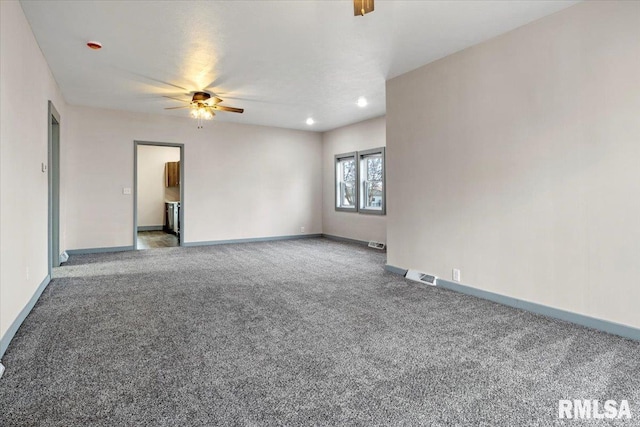 carpeted spare room with ceiling fan