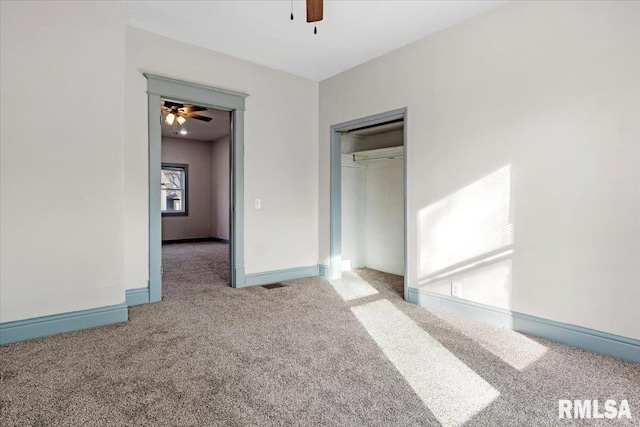 unfurnished bedroom featuring carpet flooring, ceiling fan, and a closet