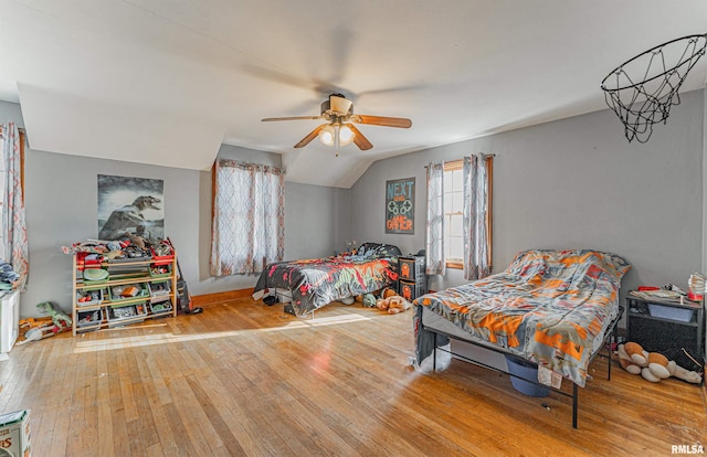 bedroom with ceiling fan, wood-type flooring, and lofted ceiling