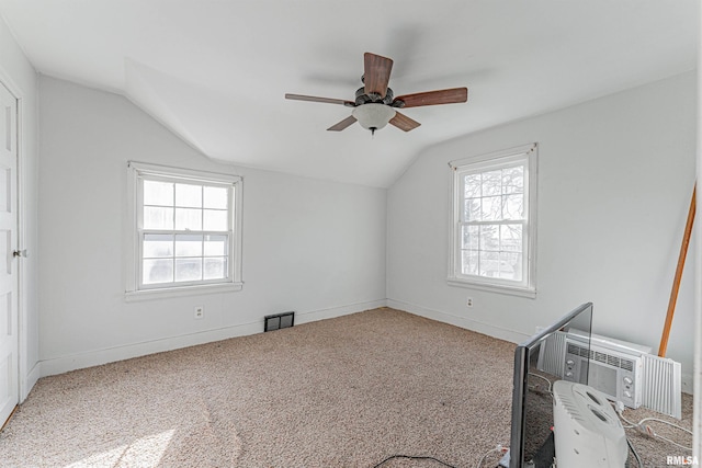 additional living space with carpet, lofted ceiling, and a wealth of natural light