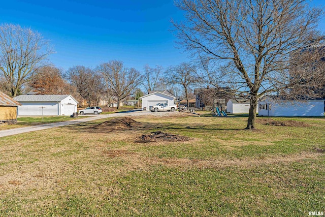 view of yard featuring a garage and a playground