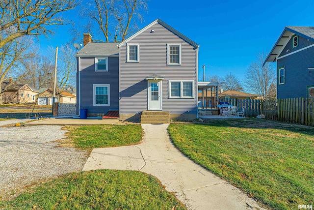 front facade featuring a patio and a front yard