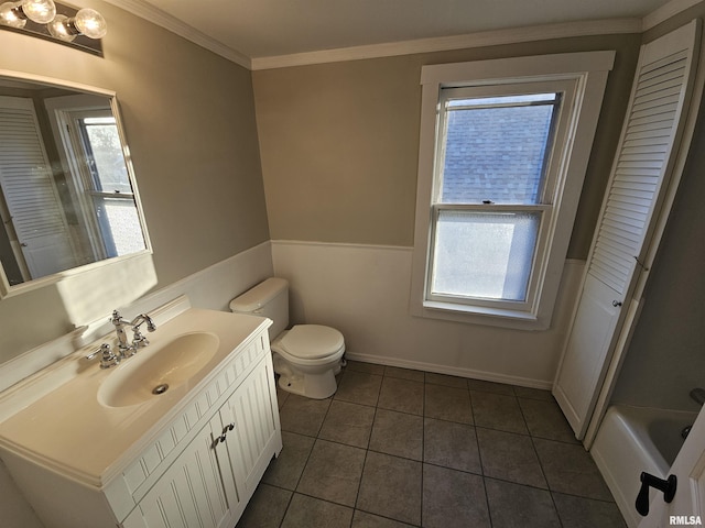 bathroom featuring tile patterned floors, vanity, a healthy amount of sunlight, and crown molding