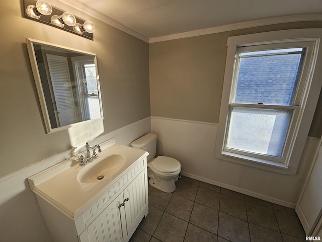 bathroom with tile patterned floors, a wealth of natural light, crown molding, and vanity