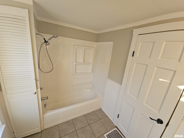 bathroom with tile patterned flooring, shower / bathtub combination, and crown molding