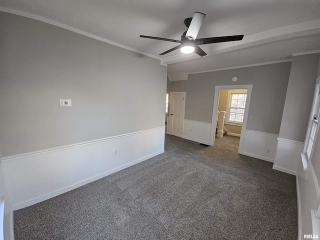 carpeted spare room with a textured ceiling, ceiling fan, and crown molding